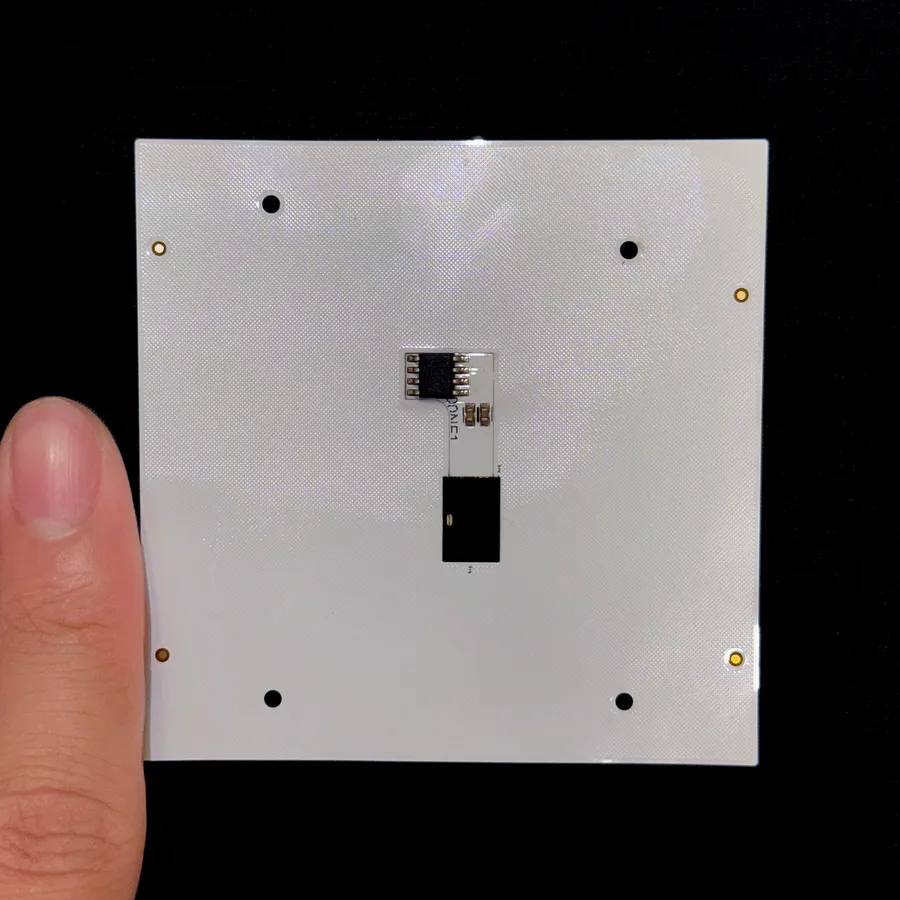 The back of the flexible PCB panel held beside a thumb, with the small eight-pin AS5070B sensor soldered on