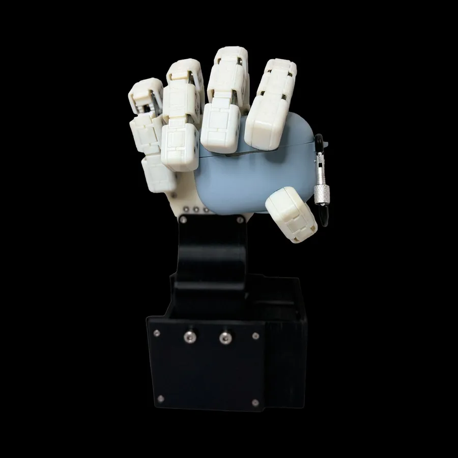 Maggie, a 3D-printed soft robotic hand, holding a pair of AirPods